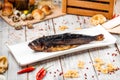 Smoked herring fish on a plate light wooden table Royalty Free Stock Photo