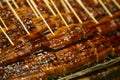 Smoked japanese eel in a market stall in Nishiki fish market in Kyoto, Japan. Royalty Free Stock Photo