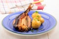 Smoked kipper with boiled potato and parsley on a plate Royalty Free Stock Photo