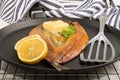 Smoked kipper with lemon, butter and parsley on a pan Royalty Free Stock Photo