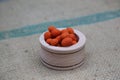 Smoked kri kri Peanuts in Small wood Bowl & texture textile slate surface