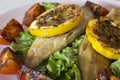 Smoked mackerel fillets with char grilled tomato and lemon on a bed of lettuce Royalty Free Stock Photo