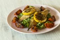 Smoked mackerel fillets with char grilled tomato and lemon on a bed of lettuce Royalty Free Stock Photo