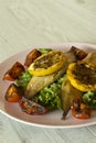 Smoked mackerel fillets with char grilled tomato and lemon on a bed of lettuce Royalty Free Stock Photo