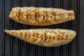 Smoked mackerel fillets cooking on a cast iron skillet griddle background Royalty Free Stock Photo