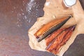 Smoked mackerel fillets on craft paper on a rustic rusty metal table. Top view Royalty Free Stock Photo