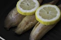 Smoked mackerel fillets with lemon in a griddle frying pan prepared for cooking Royalty Free Stock Photo