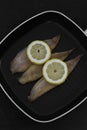 Smoked mackerel fillets with lemon in a griddle frying pan prepared for cooking Royalty Free Stock Photo