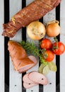 Smoked meat served with tomatoes and onions. Apple wood smoked pork loins. Sliced meat and vegetables. Royalty Free Stock Photo