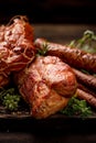 Smoked meats and sausages with addition fresh aromatic herbs, close up.