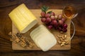 Smoked mozzarella cheese block on wood board