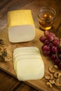 Smoked mozzarella cheese block on wood board
