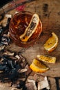 Smoked old fashioned cocktail on dark wooden background