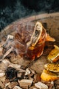 Smoked old fashioned cocktail on dark wooden background