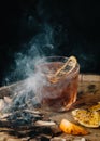 Smoked old fashioned cocktail on dark wooden background