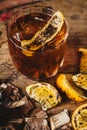 Smoked old fashioned cocktail on dark wooden background