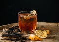 Smoked old fashioned cocktail on dark wooden background