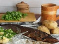 Smoked pike fish on the table with salad and potatoes