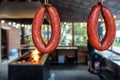 Smoked pork, beef and lamb sausage rings hanging on street market