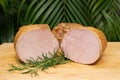 Smoked pork ham with rosemary. Cold cuts on wooden board