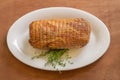 Smoked pork ham with thyme. Whole piece on a white plate Royalty Free Stock Photo
