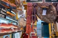 Smoked pork meat, sausages, and prosciutto for sale at the Bolzano street market. Italy