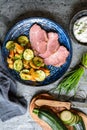 Smoked pork neck with crispy roasted potatoes and zucchini slices Royalty Free Stock Photo