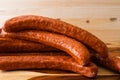 Smoked pork sausages close up on wooden background