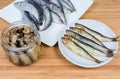 Smoked, preserved in cooking oil against of raw baltic herring Royalty Free Stock Photo