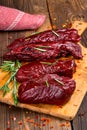 Smoked red deer maral filleted on a wooden background Royalty Free Stock Photo