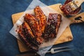 Smoked Roasted pork ribs over blue background. Barbeque spicy ri