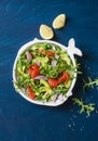 Smoked salmon, avocado, arugula, red onion salad. Healthy snacking on blue background