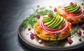 Smoked salmon with avocado and red onion on potato cakes