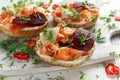 Smoked salmon bagel toasts with soft cheese, cucumber ribbons and beetroot and dill, cress salad Royalty Free Stock Photo