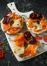 Smoked salmon bagel toasts with soft cheese, cucumber ribbons and beetroot and dill, cress salad Royalty Free Stock Photo