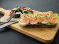 Smoked salmon bruschetta and salad on a wonden board Royalty Free Stock Photo