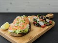 Smoked salmon bruschetta and salad on a wonden board Royalty Free Stock Photo