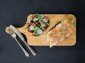 Smoked salmon bruschetta and salad on a wonden board Royalty Free Stock Photo