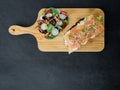 Smoked salmon bruschetta and salad on a wonden board Royalty Free Stock Photo