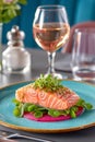 Smoked salmon carefully placed on beetroot carpaccio garnished with microgreens. Elegant restaurant setting featuring Royalty Free Stock Photo