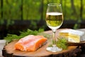 smoked salmon on cedar plank with glass of white wine