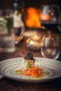 Smoked salmon with cheese, onion and herbs served on plate with glass of wine and toast, modern gastronomy Royalty Free Stock Photo