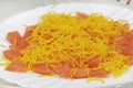 Smoked salmon cut into pieces decorated with angel hair