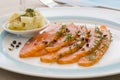 Smoked salmon and ingredients in plate on table