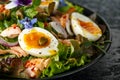 Smoked salmon and jammy soft-boiled free range egg and capers salad with edible borage and pansy flowers