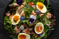 Smoked salmon and jammy soft-boiled free range egg and capers salad with edible borage and pansy flowers