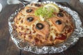 Smoked salmon pizza on wooden table.