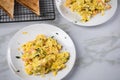 Smoked salmon with scrambled eggs, whole grain bread toast and dill on marble background Royalty Free Stock Photo