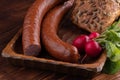 smoked sausage with bread and radish, rustic food on a wooden table Royalty Free Stock Photo