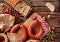 Smoked sausage with bread and spices on a old wooden table Royalty Free Stock Photo